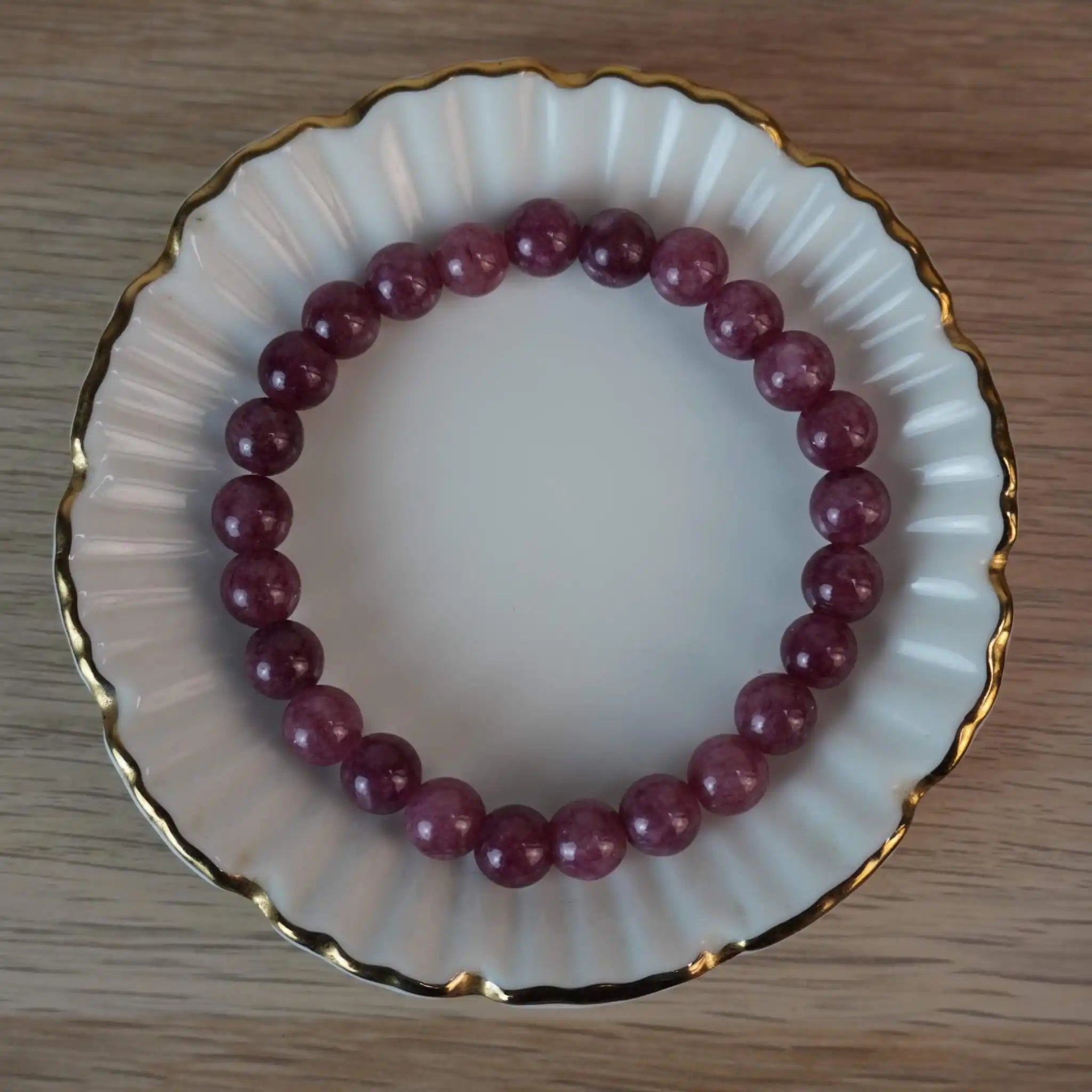Erdbeerquarz Kugelarmband in eleganter Schmuckschale mit Goldrand