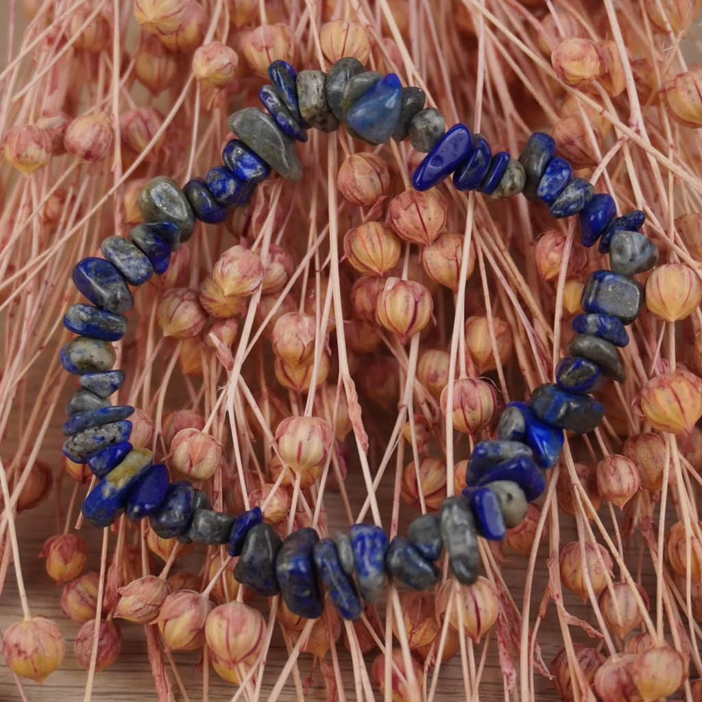 Lapislazuli‑Splitterarmband vor rosafarbenen Trockenblumen