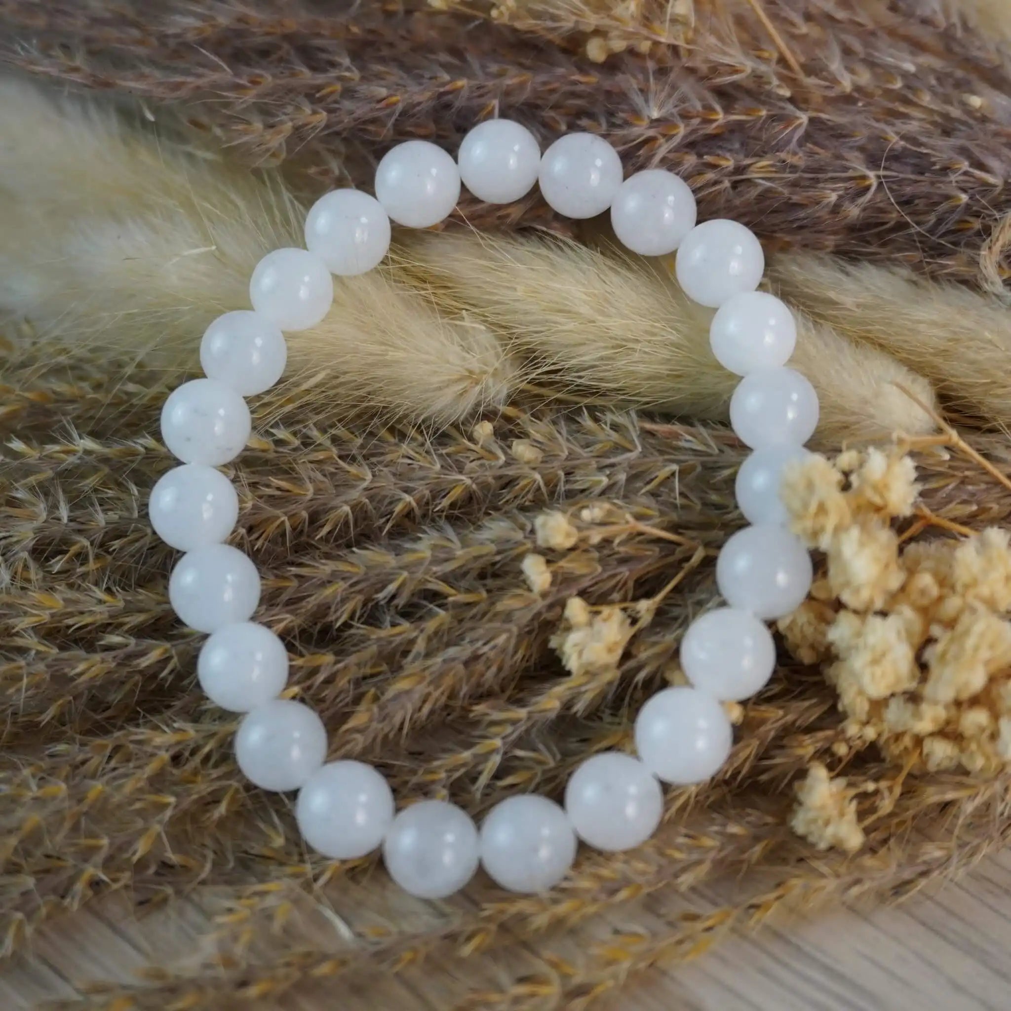Mondstein Kugelarmband dekorativ auf Trockenblumen platziert