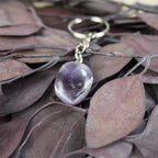 Amethyst Trommelstein Schlüsselanhänger auf braunen Blättern 
