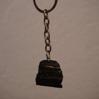 Schwarzer Turmalin Schlüsselanhänger frei hängend vor neutralem Hintergrund